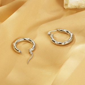 Detailed view of silver U-shaped stainless steel hoop earrings with sparkling cubic zirconia