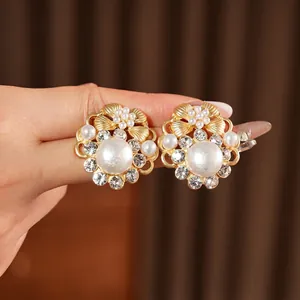 Vintage style gold earrings with large pearl, sparkling rhinestones and crystal flower accents