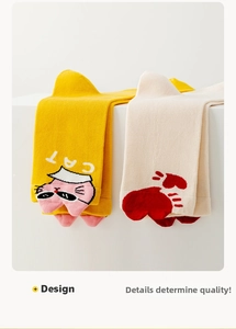Detail of yellow cat themed and white heart cotton socks showing high-quality rib cuffs