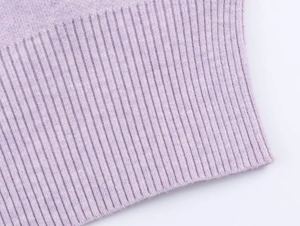 Macro shot of light purple knitwear showing detailed ribbed texture and soft wool blend