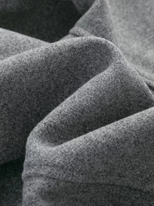 Macro detail of high-quality grey wool fabric texture with soft plush fiber surface