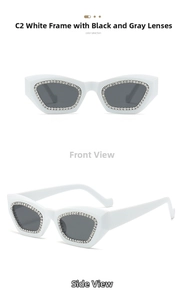 Detail view of white cat-eye sunglasses with rhinestone borders and dark grey lenses