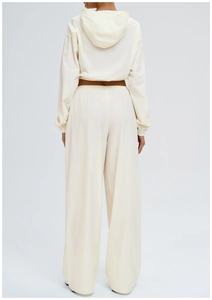 Rear view of women's loose outdoor pants and cropped hoodie set in creamy white