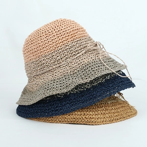 Close-up of four handmade crochet sun hats showing detailed woven texture and colors