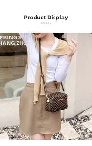 Model wearing a small vintage brown floral print crossbody bag with gold hardware detail