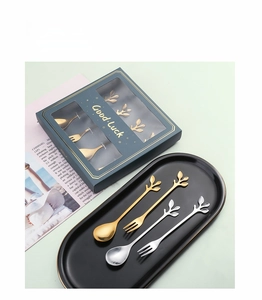 Detail of creative leaf handle stainless steel spoon and fork set in a luxury gift box