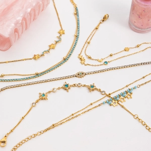 18K gold stainless steel jewelry set featuring evil eye moon and star charms with blue beads