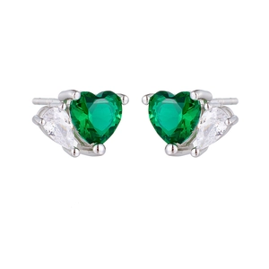 Detailed macro view of S925 silver heart studs with emerald green and pear-cut cubic zirconia
