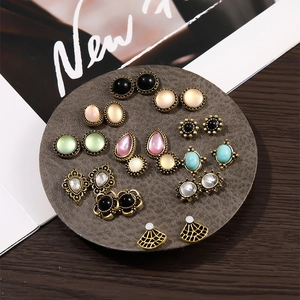 Flat lay of retro-style stud earring set featuring various colorful faux gemstones on a pad