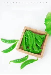 Detailed view of artificial green snow peas model with realistic vegetable pod texture