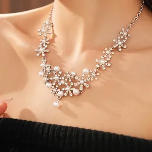 Elegant floral pearl necklace set with shimmering rhinestones and a teardrop pendant