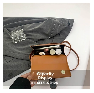 Detail view of brown leopard handbag interior showing capacity for smartphone and lipstick