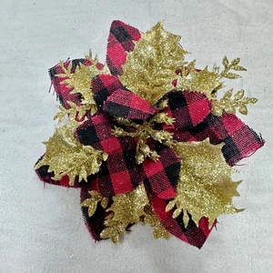 Close-up of red and black buffalo plaid Christmas flower with gold glitter edges
