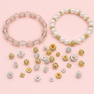 Detailed view of DIY jewelry beads with pink crystals and sparkling rhinestone spacers