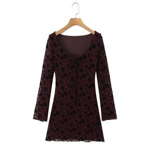 Deep burgundy floral long sleeve mini dress with a low neckline on a wooden hanger