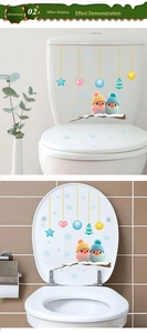 Detail of Christmas toilet lid stickers featuring colorful birds and snowflake ornaments