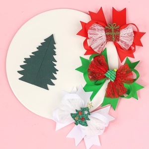 Close-up of glittery Christmas bow clips with ribbon lace and festive ornaments