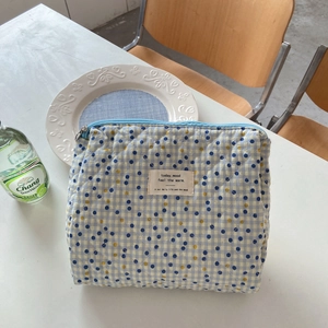 Quilted floral makeup bag with blue plaid and polka dot pattern for travel storage