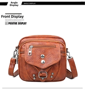 Détail de face du sac à bandoulière vintage marron avec plusieurs poches zippées