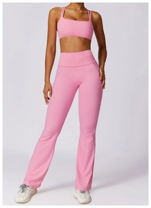Detailed full-body shot of a pink high-stretch yoga set with a sports bra and flared pants
