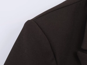 Close-up of coffee brown blazer lapel showing fine twill fabric texture and stitching