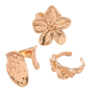 Three-piece rose gold ring set featuring flower design and irregular hammered textures