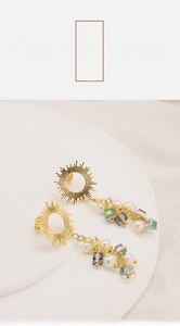Detailed close-up of 18k gold plated sunburst earrings with natural freshwater pearls