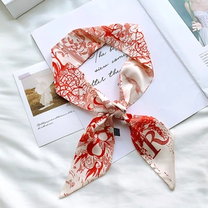 Detail of red and white twilly silk scarf featuring vintage floral print and letter R