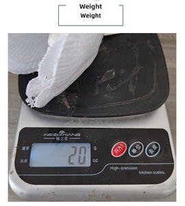 Detailed scale view showing the weight of a white artificial glitter Christmas flower