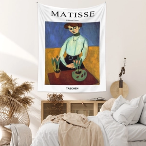 Detail of Matisse art tapestry with TASCHEN cover style on a cozy bedroom wall