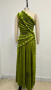 Detail view of the elegant grass green velvet fabric with intricate twisted knot pleats