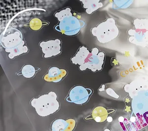 Detail of space bear nail stickers featuring astronauts and planets with metallic luster