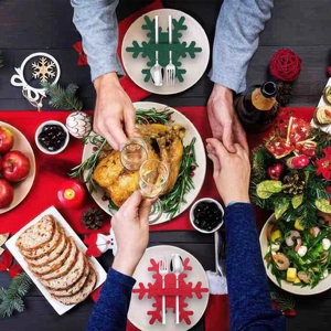 Detail of red and green snowflake felt cutlery holders on a festive Christmas dinner table