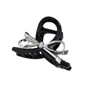 Elegant black bow hair claw clip with silver metal accents for stylish updos