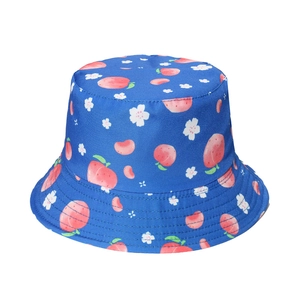 Close-up of navy bucket hat featuring peach patterns and detailed stitching on the brim