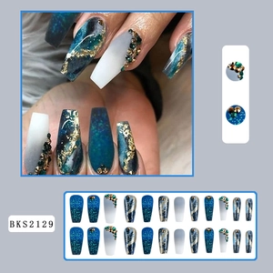 Blue gradient press-on nails with marble texture, gold foil, and rhinestone accents