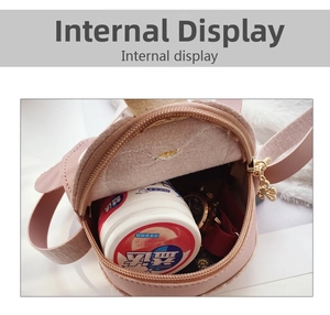 Internal display of mini round penguin bag showing PU leather interior and metal zipper