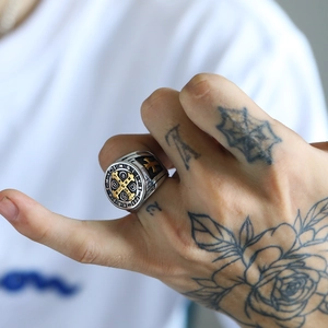 Close-up of vintage Saint Benedict cross seal ring in silver and gold steel