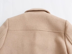 Detailed close-up of camel wool jacket showing collar stitching and premium fabric texture