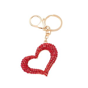 Golden heart keychain with red rhinestones on a white background for bag charm