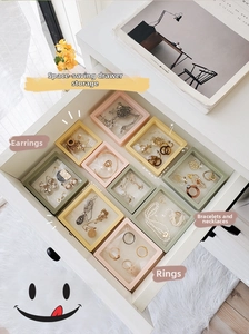 Detail view of macaron PE film jewelry display cases organized in a white drawer