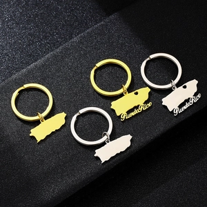 Detailed close-up of Puerto Rico map keychains in gold and silver stainless steel