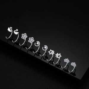 S999 sterling silver hollow cat and swan stud earrings set on black mirror background