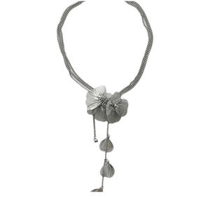 Detailed view of silver layered necklace with 3D metal flowers and leaf tassel pendants