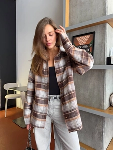 Close-up of brown and beige plaid pattern on comfortable long sleeve cotton shirt