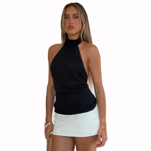 French style halter neck knitted top in black paired with a white mini skirt for women