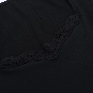 Detailed close-up of delicate black lace edging on a square neck long sleeve mini dress
