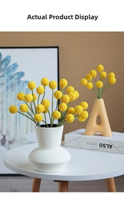 Close-up of artificial yellow Billy Buttons in a white textured vase for home decor