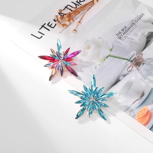 Exquisite starburst crystal brooch with colorful rhinestones in an elegant setting