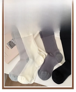 Detailed texture of vertical ribbed mesh thin crew socks in neutral color tones